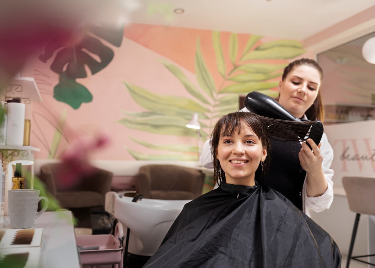 Woman getting a haircut at a salon